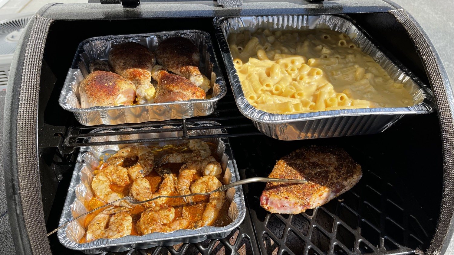 Drumsticks, New York strip, shrimp, and mac on the smoker